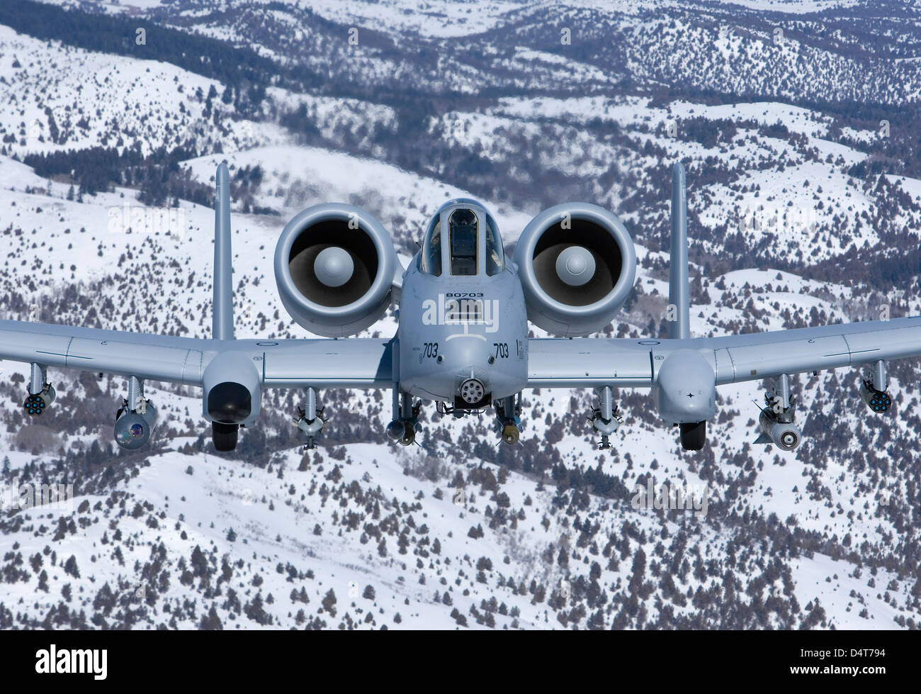 An A-10C Thunderbolt flies over the snowy Idaho countryside. Stock Photo