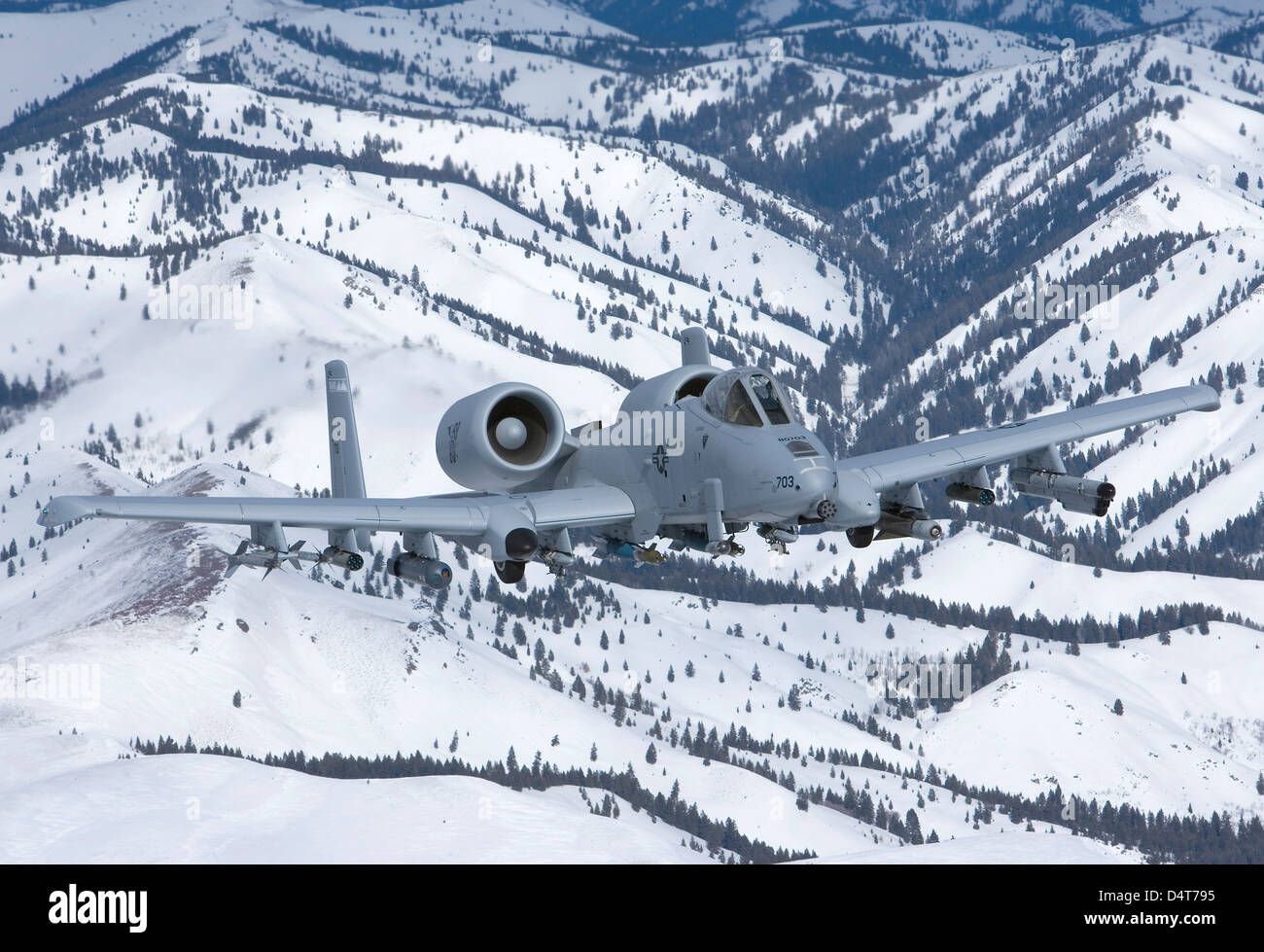 An A-10C Thunderbolt flies over the snowy Idaho countryside. Stock Photo
