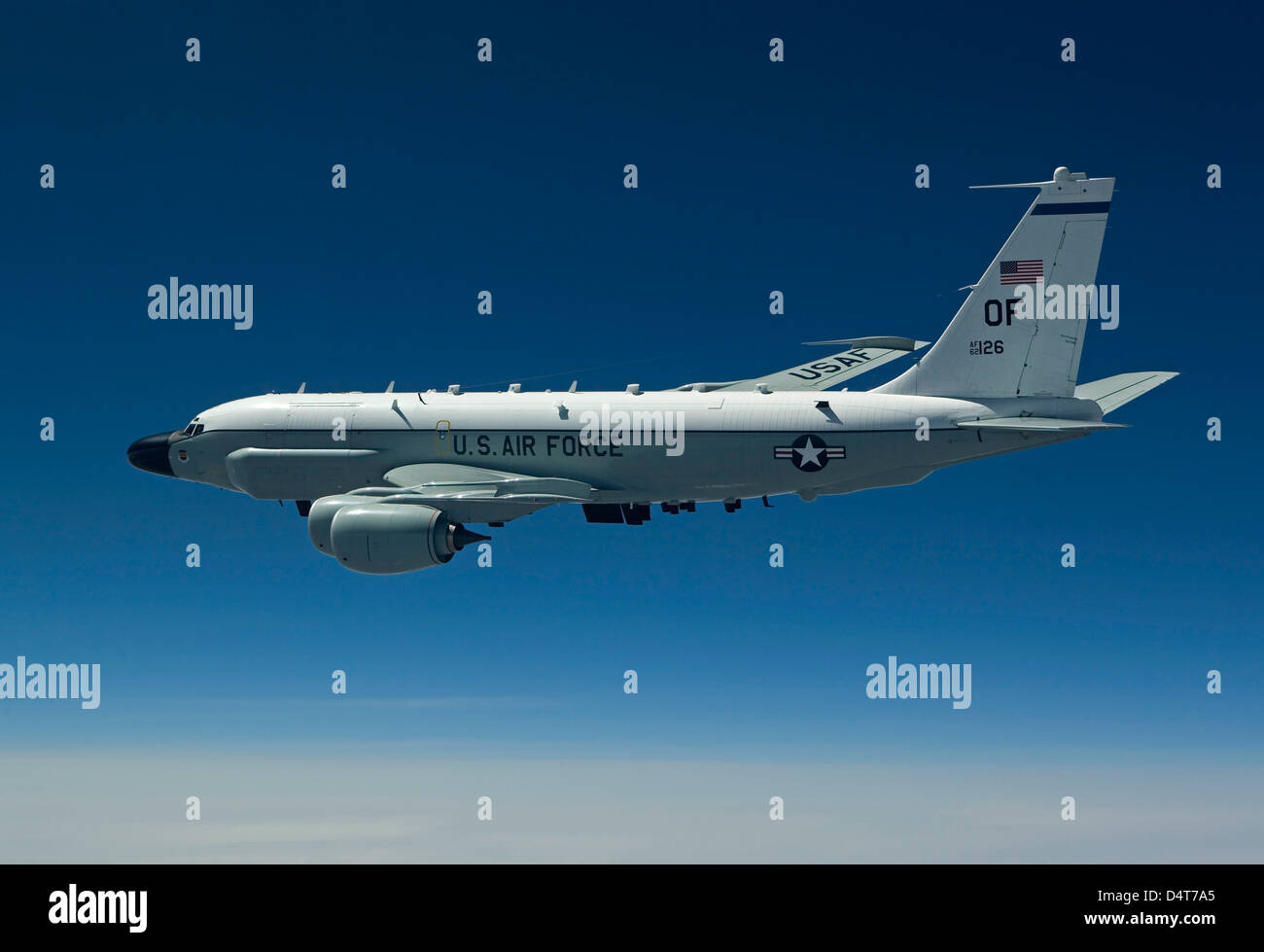 An RC135W Rivet Joint aircraft flies high over the Midwest on a