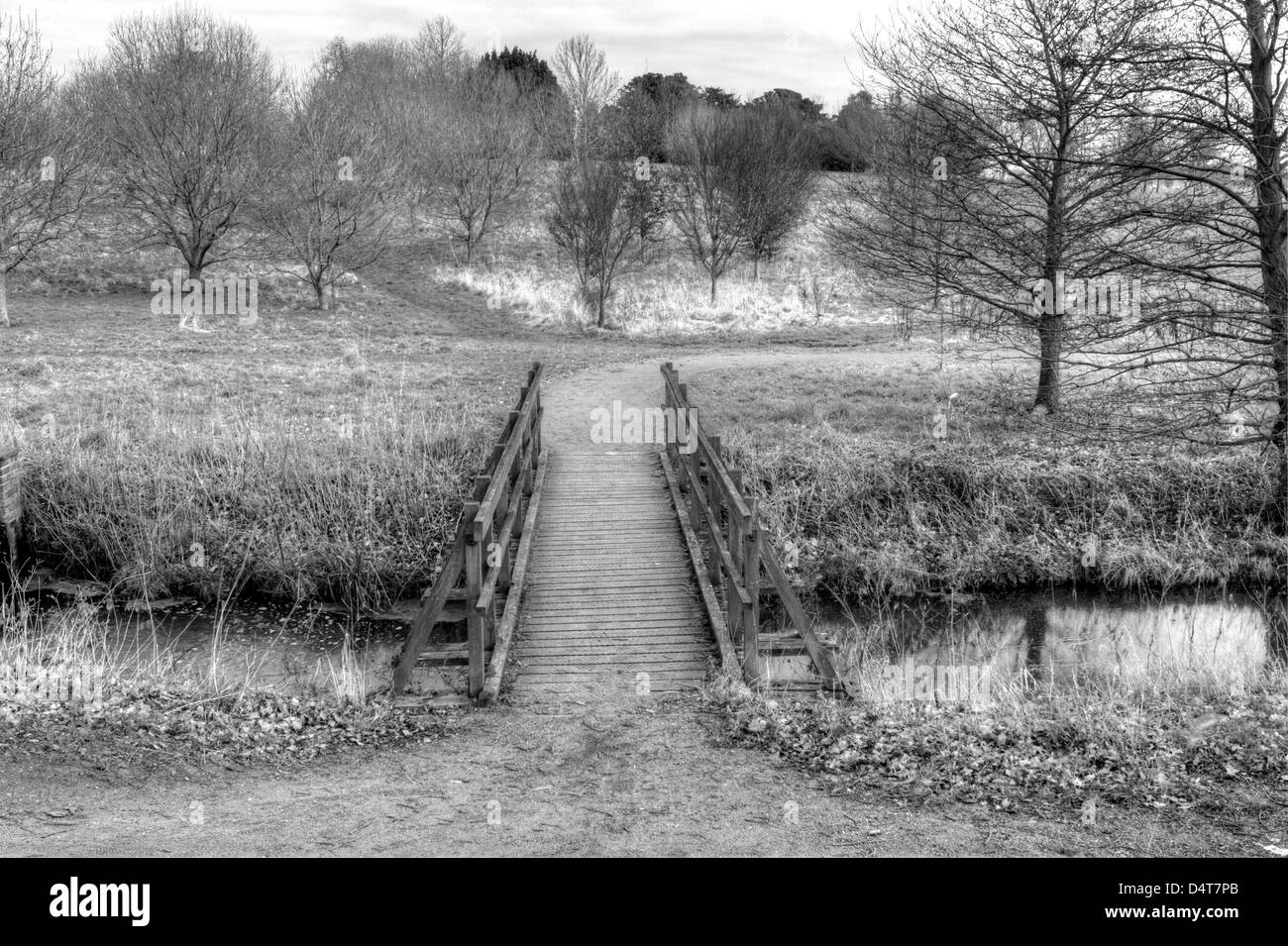 Marks Hall Estate. A view of the English countryside. A bridge over river in an english countryside scene on a stormy day Stock Photo
