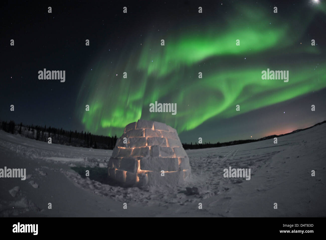 Aurora borealis over an igloo on Walsh Lake, Yellowknife, Northwest