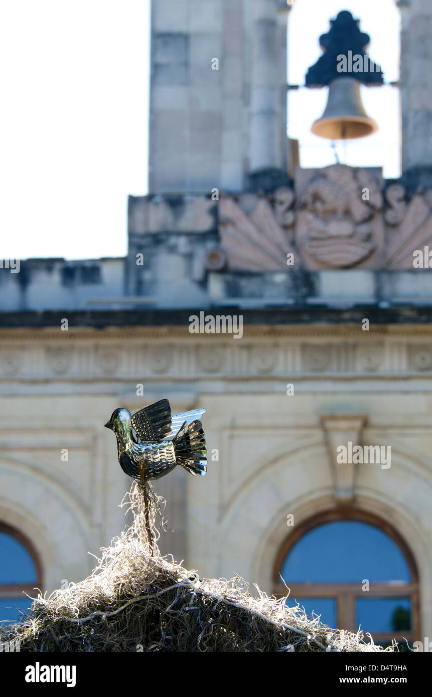 The dove on top of a nativity scene in Oaxaca's Zocalo, and the bell in the Palacio de Gobierno. (Mexico) Stock Photo