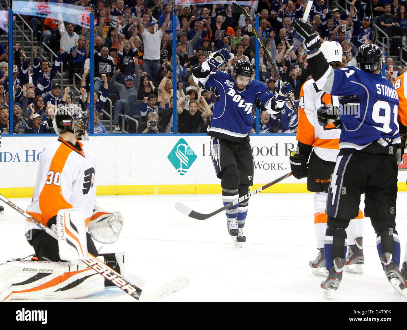 March 18, 2013 - Tampa, Florida, U.S. - DIRK SHADD   |   Times  .Tampa Bay Lightning right wing Teddy Purcell (16) (in center) celebrates scoring off a deflection to beat Philadelphia Flyers goalie Ilya Bryzgalov (30) (left) for the go-ahead goal during third period action at the Tampa Bay Times Forum in Tampa Monday evening 03/18/13. On right is center Steven Stamkos (91), who also picked up an assist and went on to score an empty net goal for his 200th career goal. (Credit Image: © Dirk Shadd/Tampa Bay Times/ZUMAPRESS.com) Stock Photo