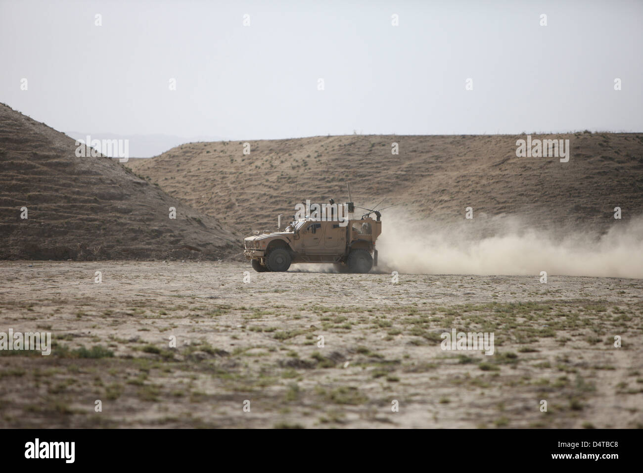 An M-ATV races across the wadi near Kunduz, Afghanistan. Stock Photo