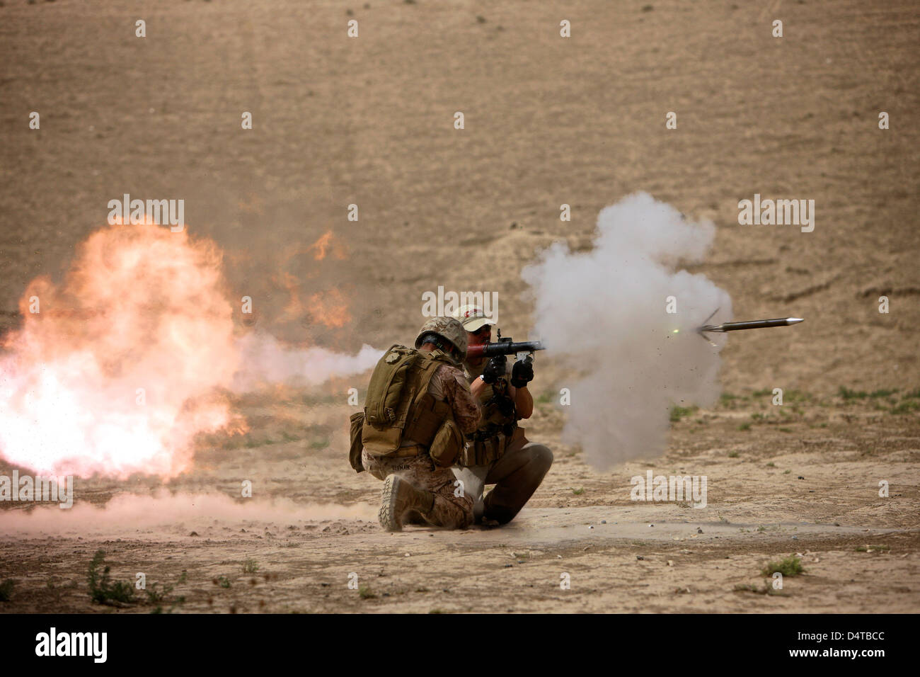 A U.S. Contractor fires a rocket-propelled grenade launcher. Stock Photo
