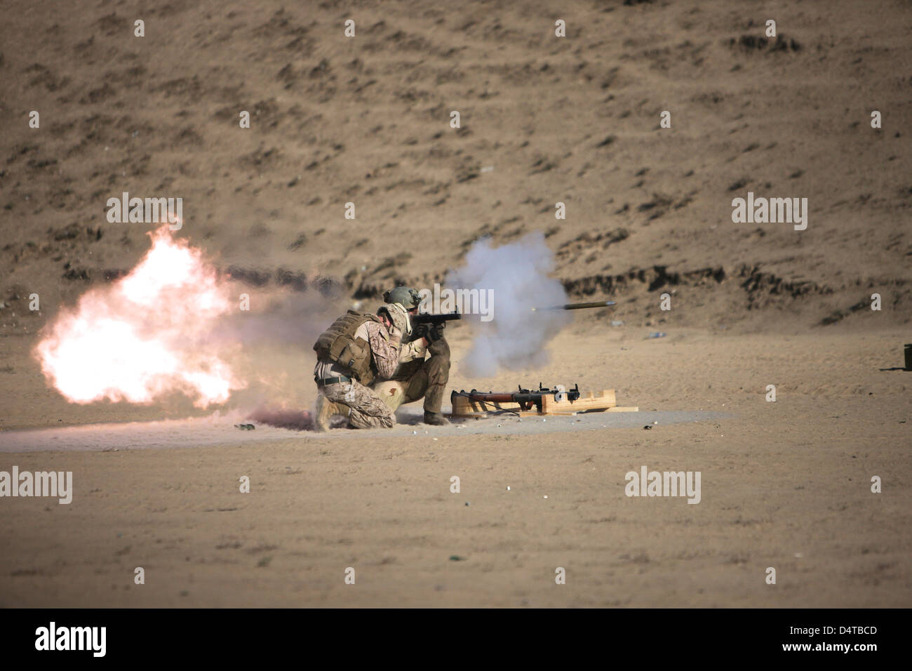 A soldier fires a rocket-propelled grenade launcher. Stock Photo