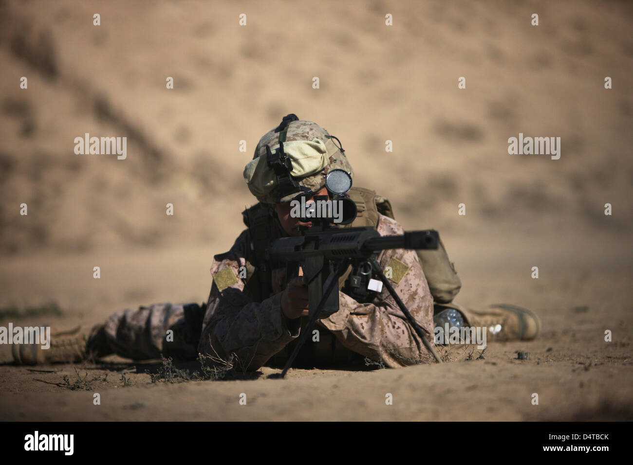 A U.S. Marine sights in a Barrett M82A1 rifle on a range in Kunduz, Afghanistan. Stock Photo