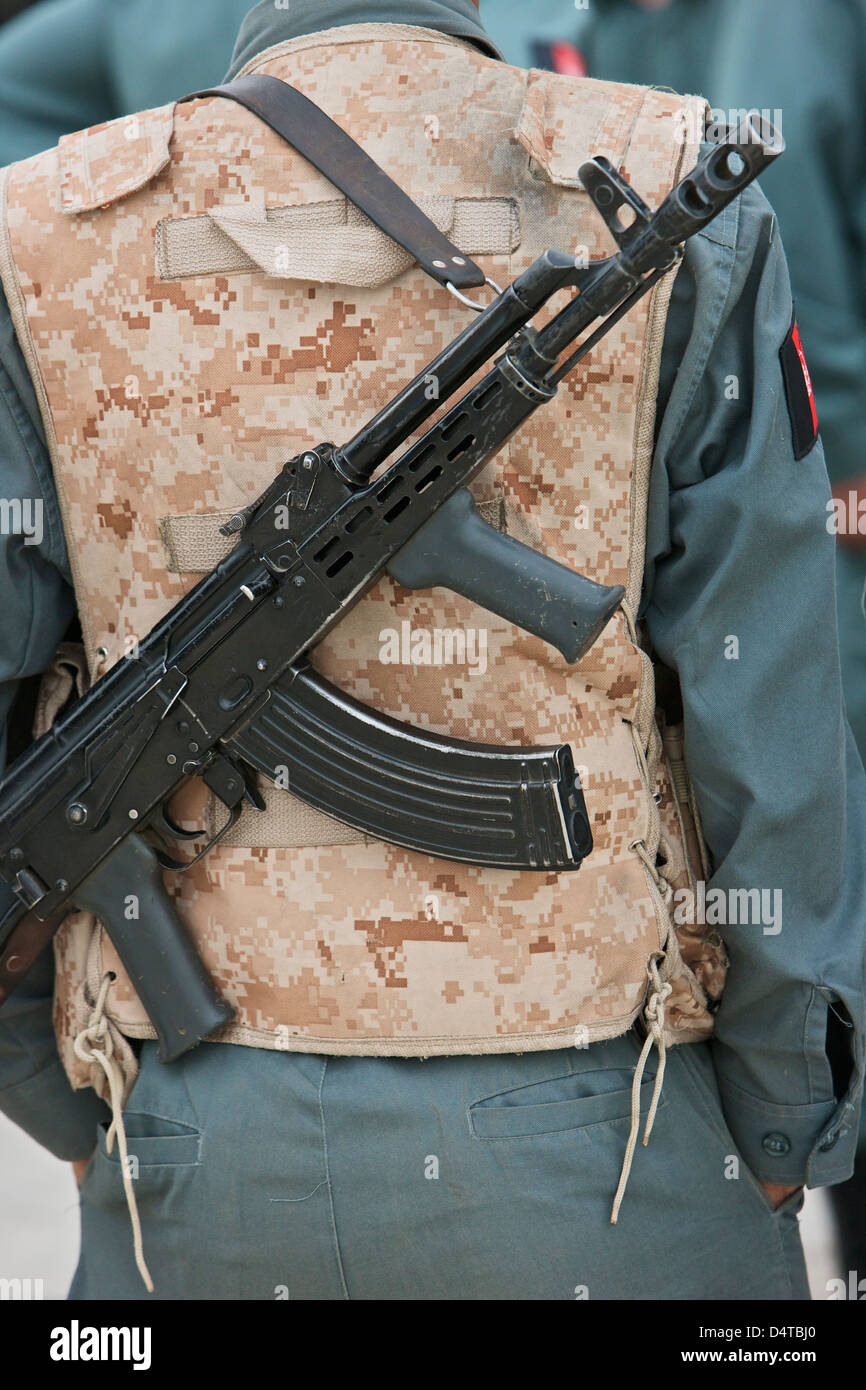 An AK47 rests on the sling of an Afghan Police Officer while visiting