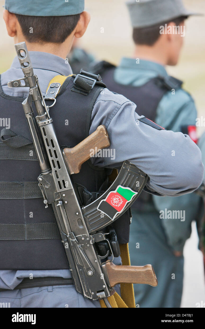 An AK47 rests on the sling of an Afghan Police Officer while visiting