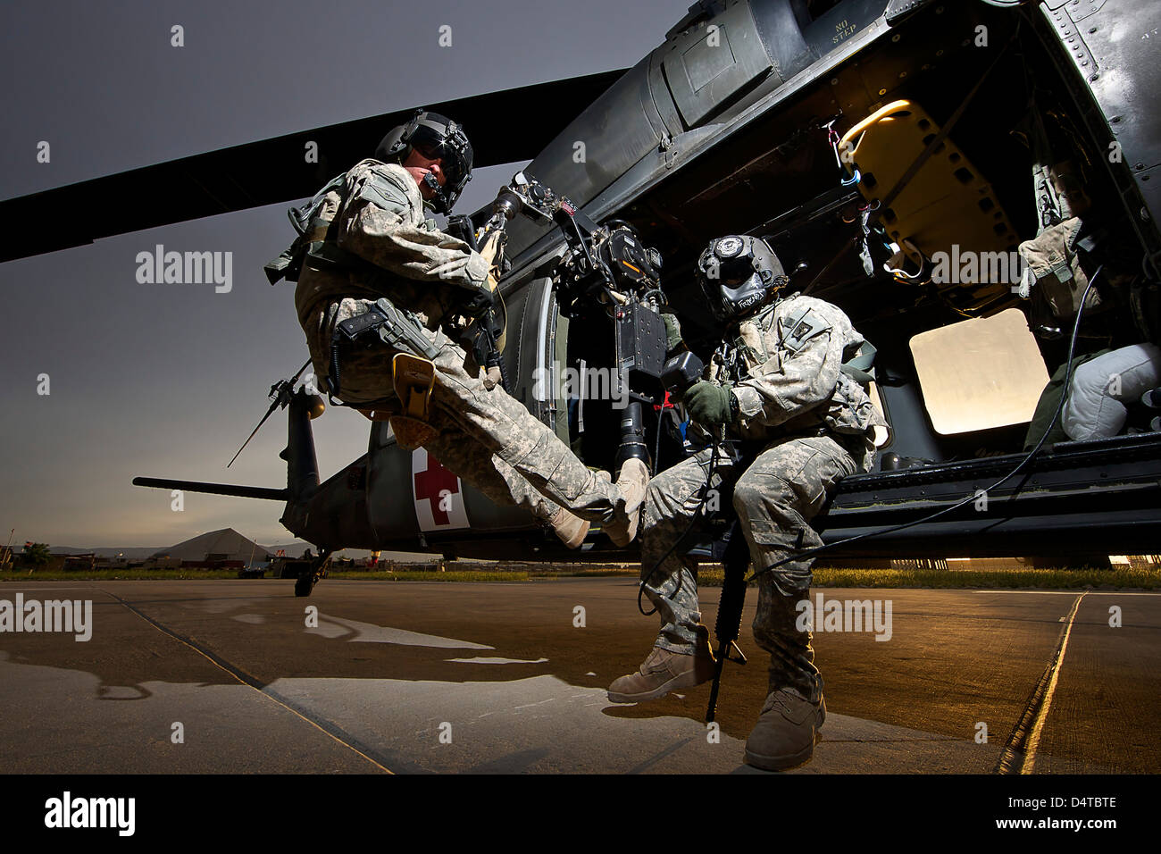 U.S. Army crew strapped into the medevac hoist of a UH-60L Black Hawk. Stock Photo
