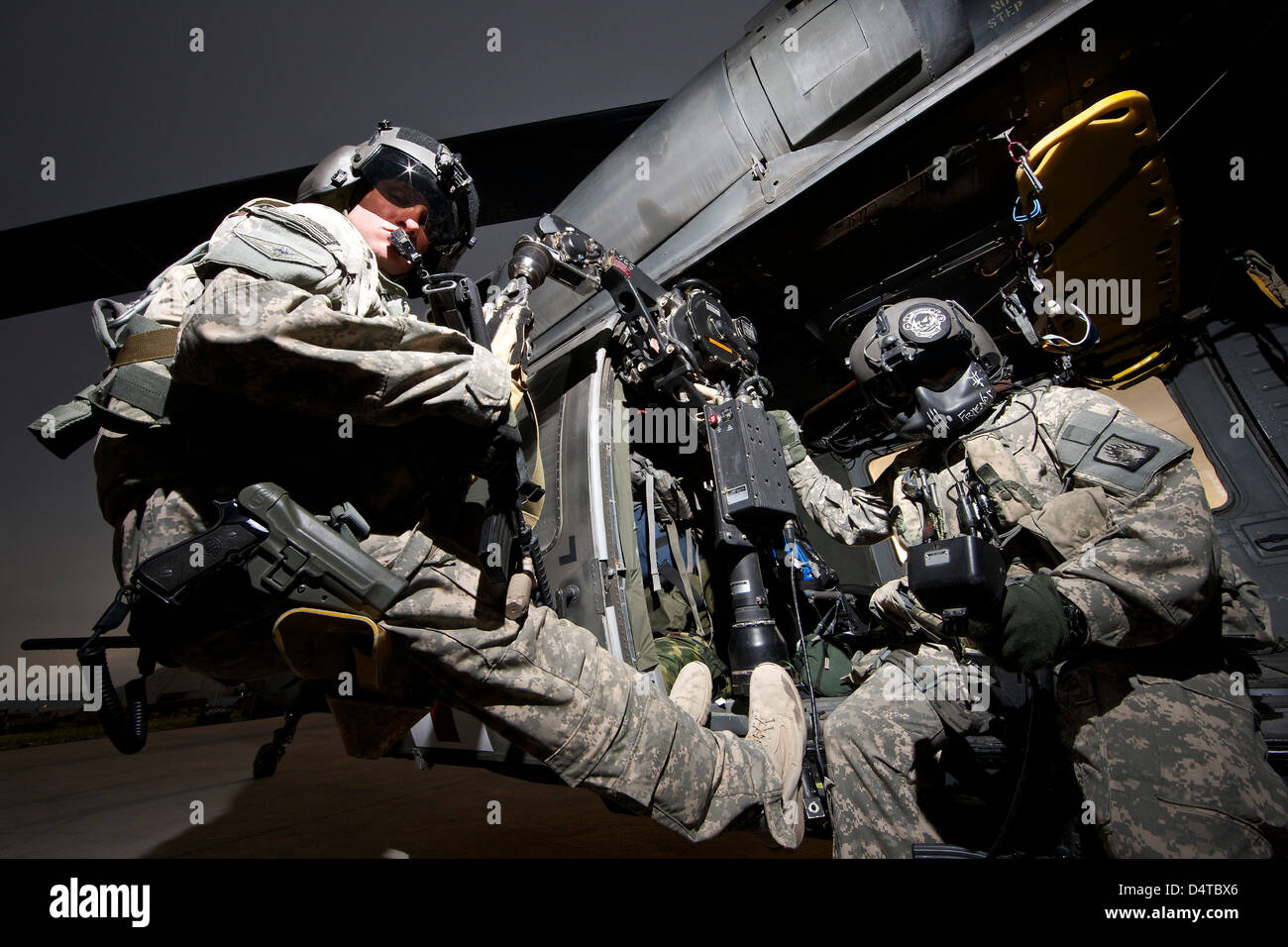 U.S. Army crew strapped into the medevac hoist of a UH-60L Black Hawk. Stock Photo
