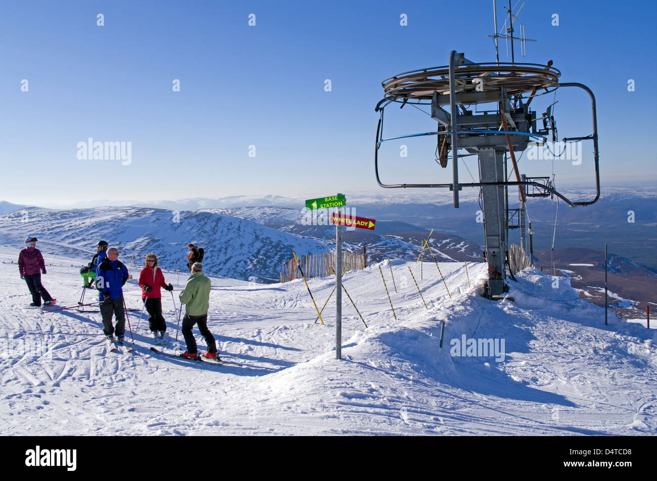 Group of skiers and snowboarders at top of M1 poma ski tow, Cairngorm mountain ski centre, Aviemore, Cairngorms National Park UK Stock Photo