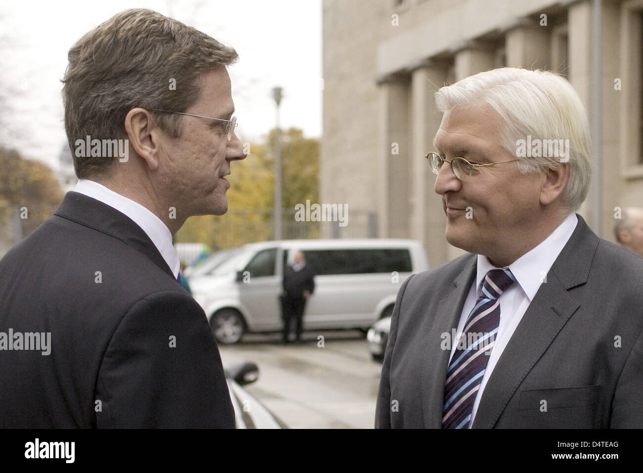 German Foreign Minister Guido Westerwelle (Liberal Democrats, L) says goodbye to former German Foreign Minister and Vice Chancellor Frank-Walter Steinmeier (Social Democrats) in front of the Ministry of Foreign Affairs in Berlin, Germany, 29 October 2009. Photo: ARNO BURGI Stock Photo