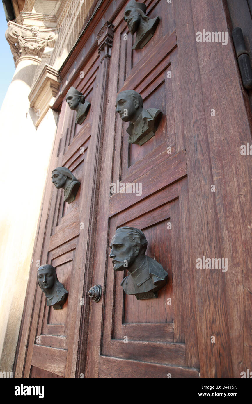 Busts on the door of Mariacki door, Krakow, Poland Stock Photo