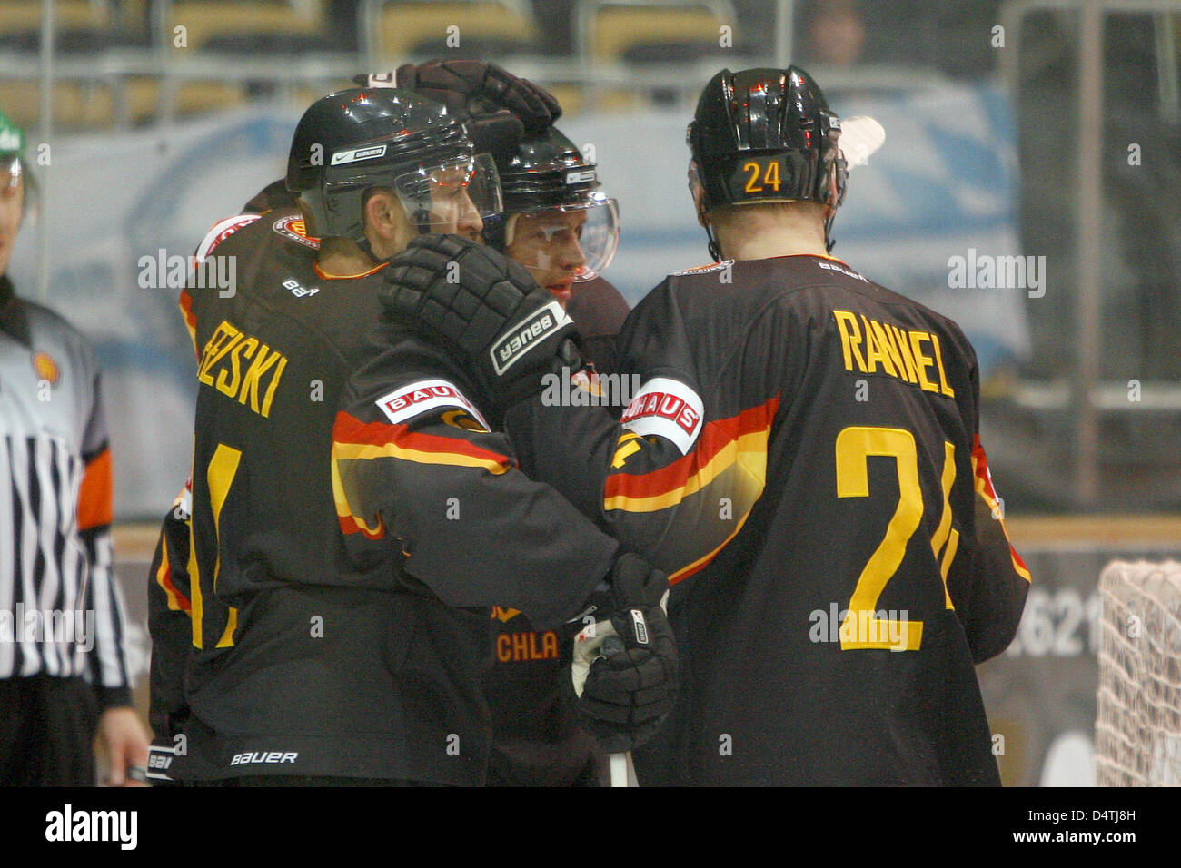 Germans Manuel Klinge (C) celebrates his 2-0 score with teammates Sven Felski (L) and Andre Rankel during the German Cup ice hockey match Germany vs Switzerland at Olympiahalle in Munich, Germany, 08 November 2009. Germany defeated Switzerland 5-1. Photo: Daniel Karmann Stock Photo