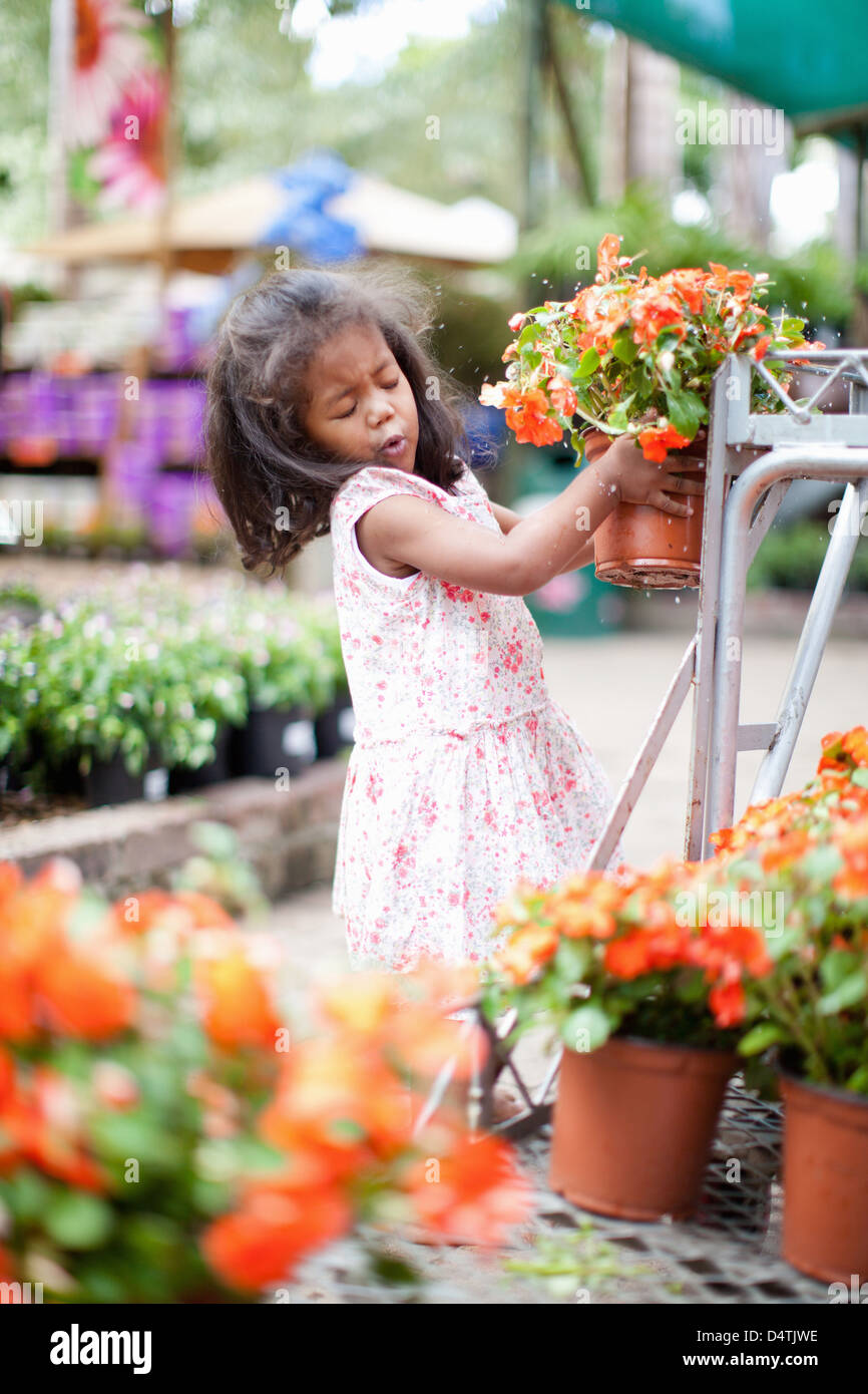 Girl holding potted plant in nursery Stock Photo - Alamy