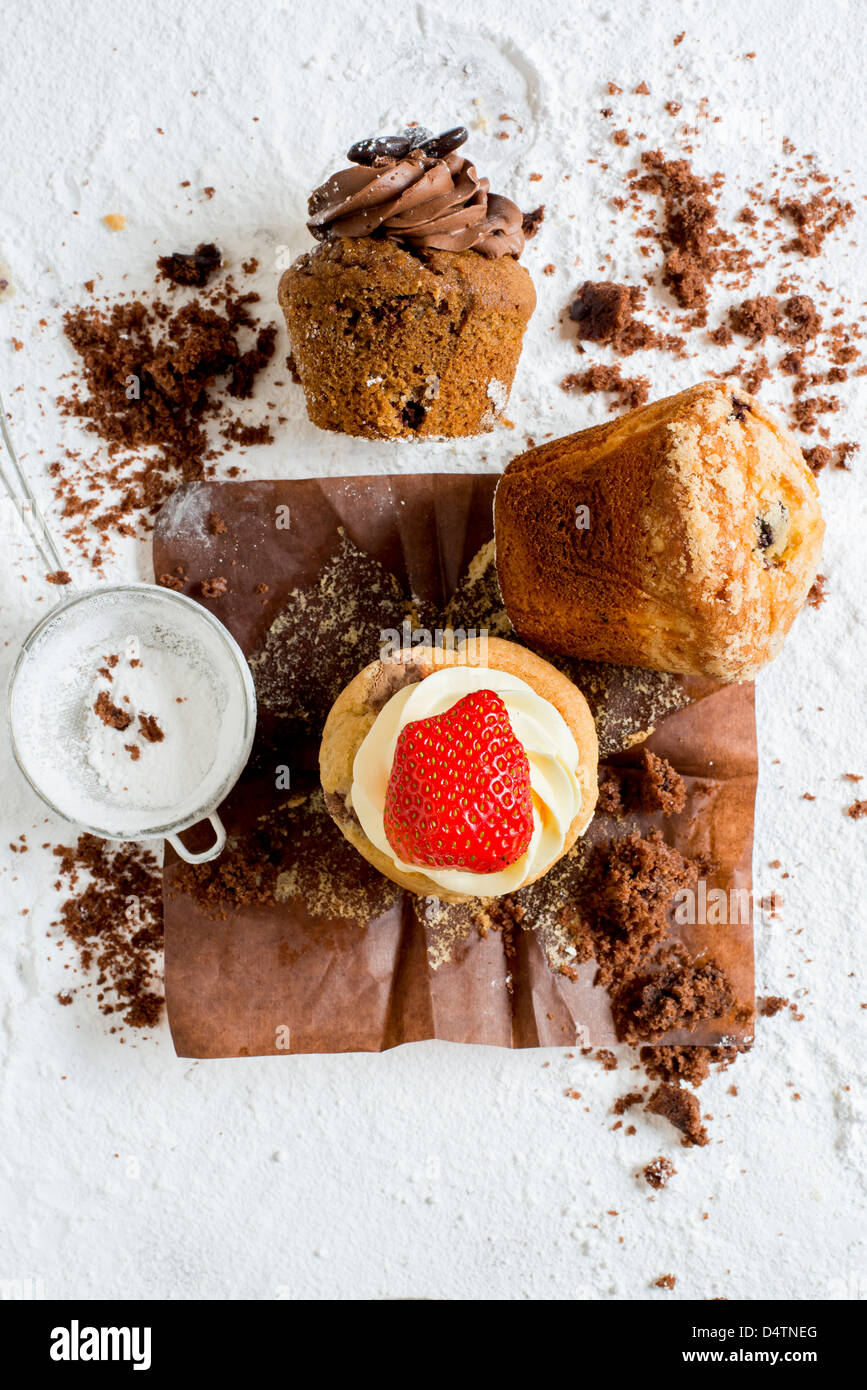 A colourful selection of muffins and cupcakes surrounded by crumbs Stock Photo Alamy