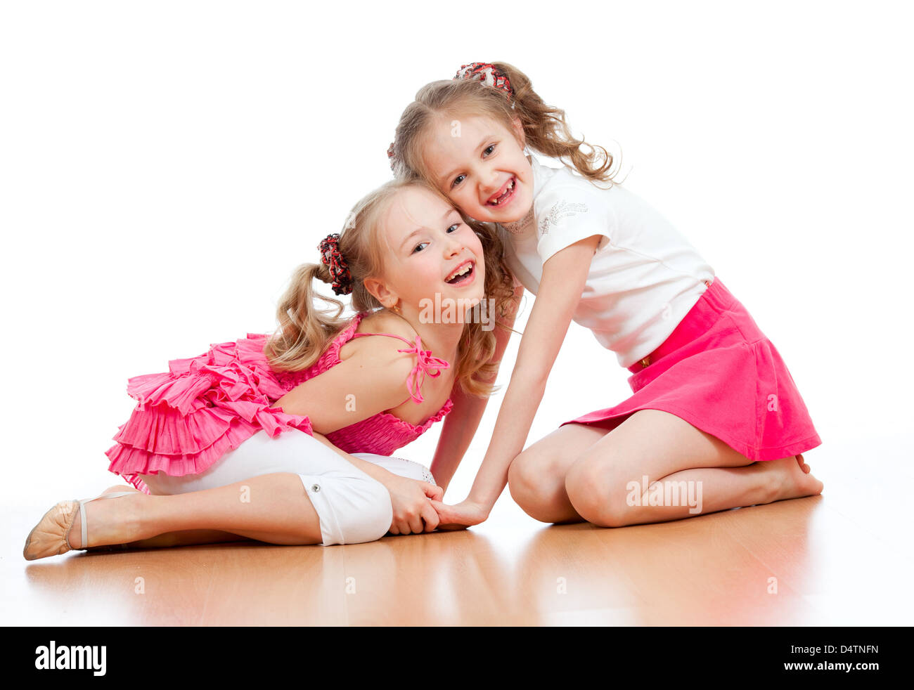 Two girls are playing together. Isolated over white background Stock Photo
