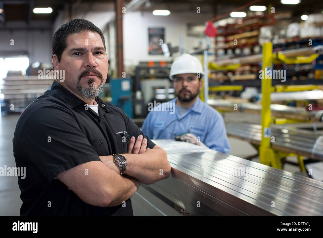 Worker standing in metal plant Stock Photo