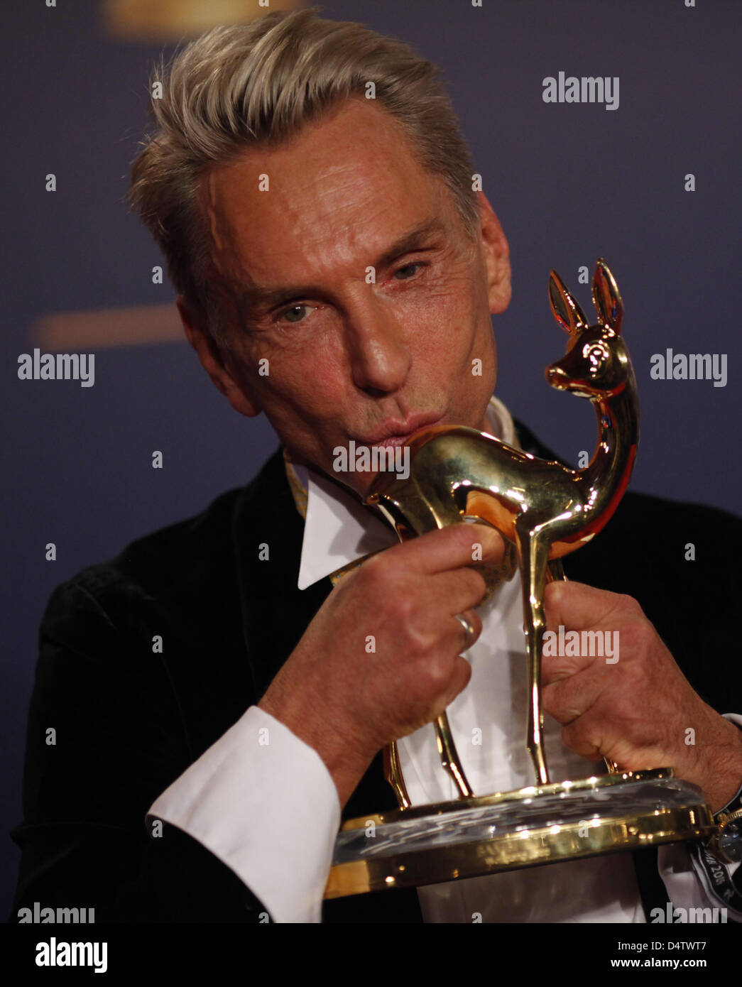 German designer Wolfgang Joop poses with his trophy during the Bambi