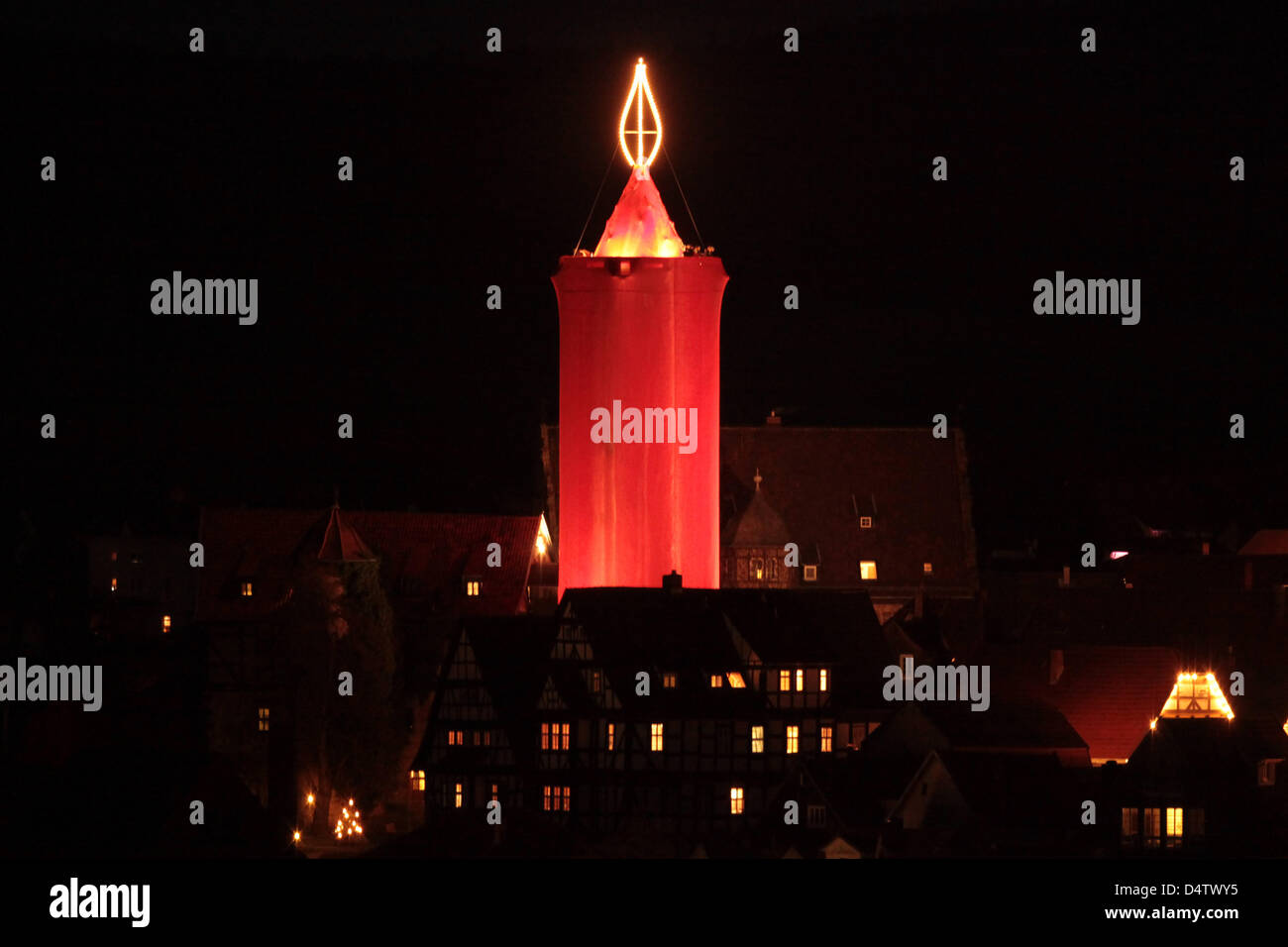 A steeple is covered with red cloth to form the world's largest candle