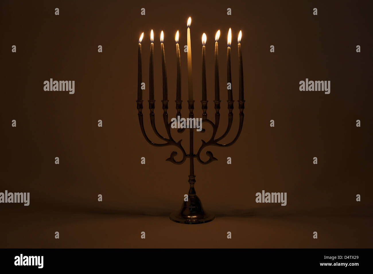 Menorah with lit candles Stock Photo