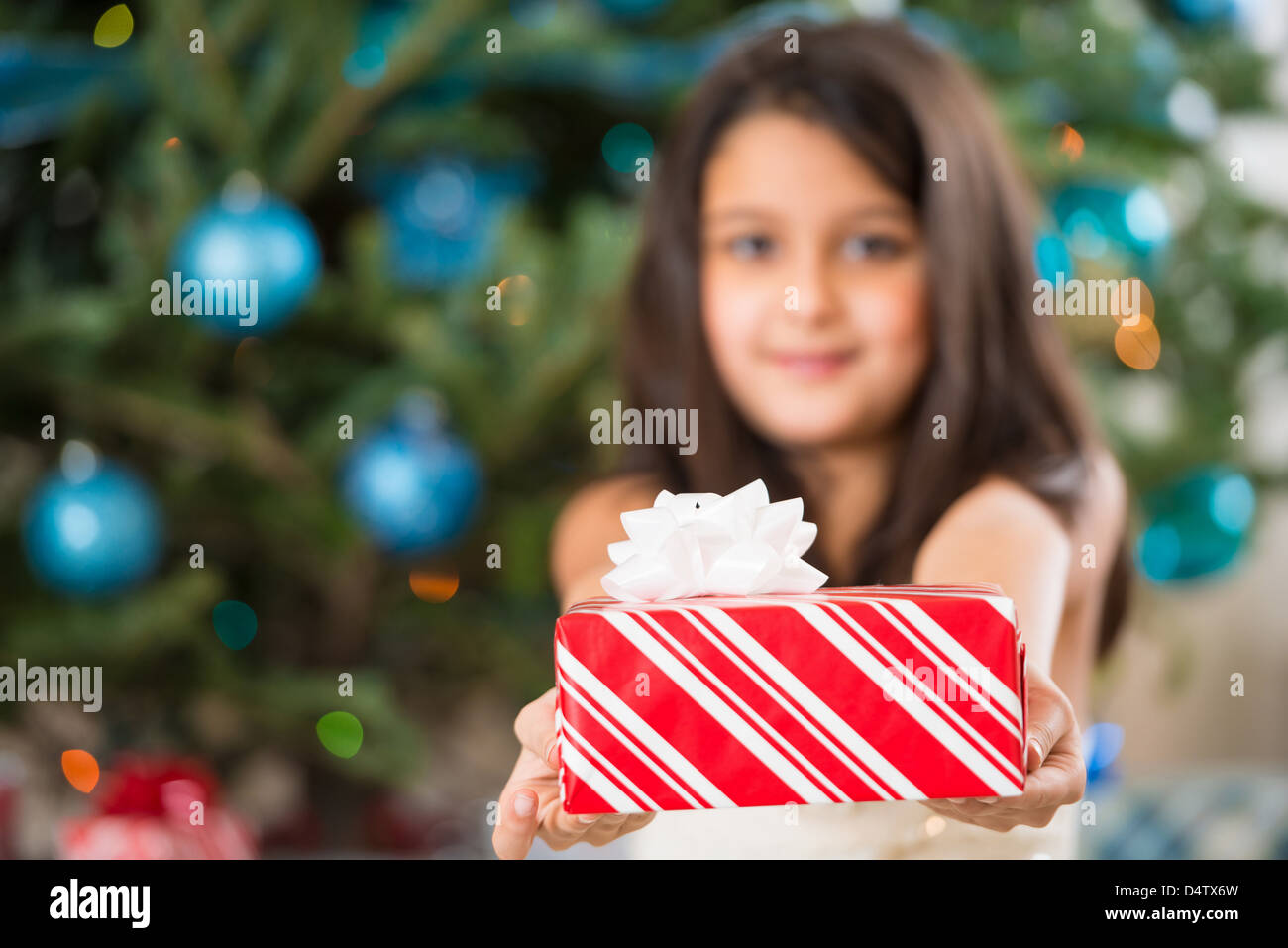 Girl holding Christmas present Stock Photo - Alamy