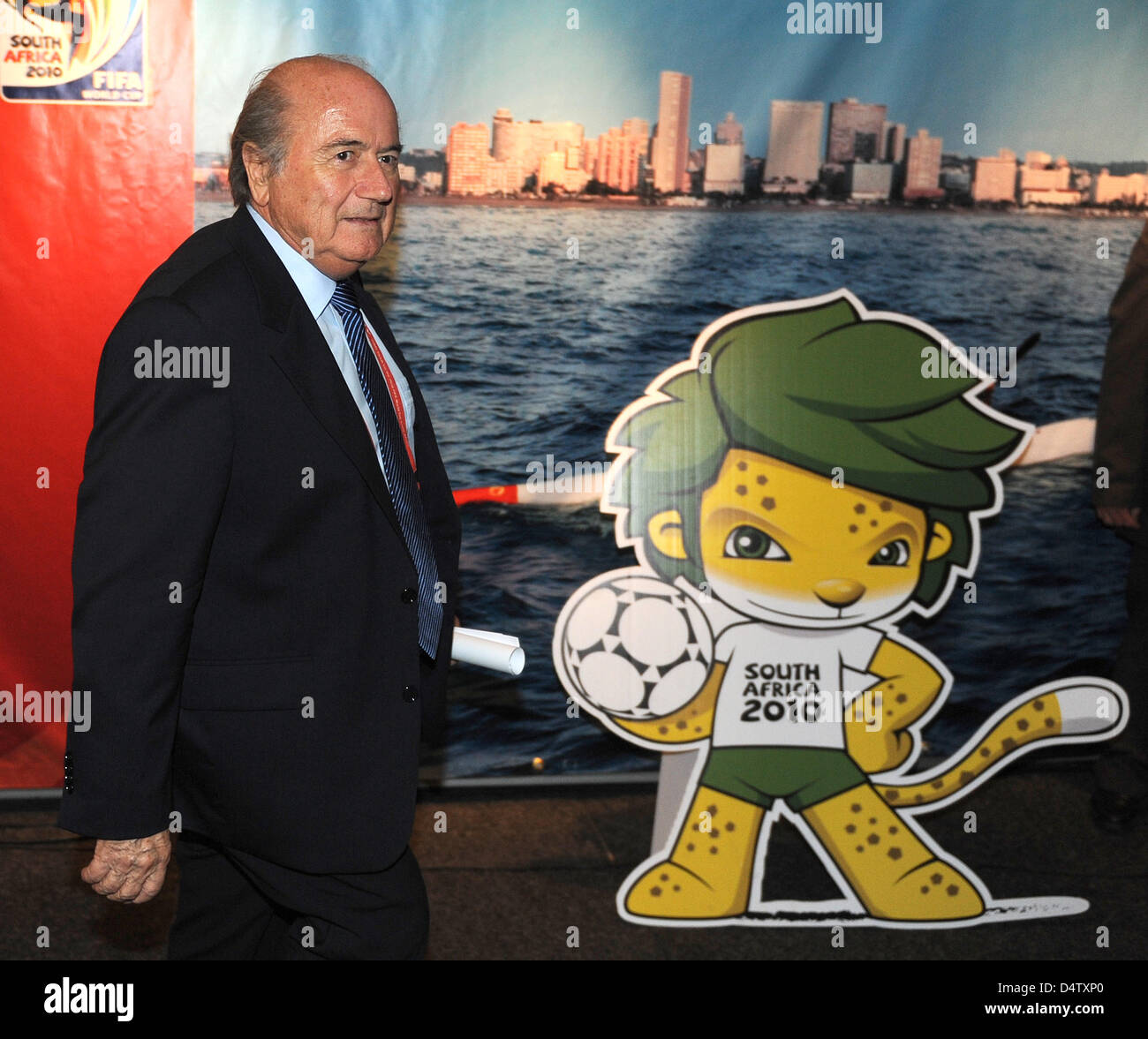 Joseph Blatter, President of the International Federation of Association Football (FIFA),walks past the mascot Zakumi on his way to a press conference in Cape Town, South Africa, 02 December 2009. Photo: Bernd Weissbrod Stock Photo