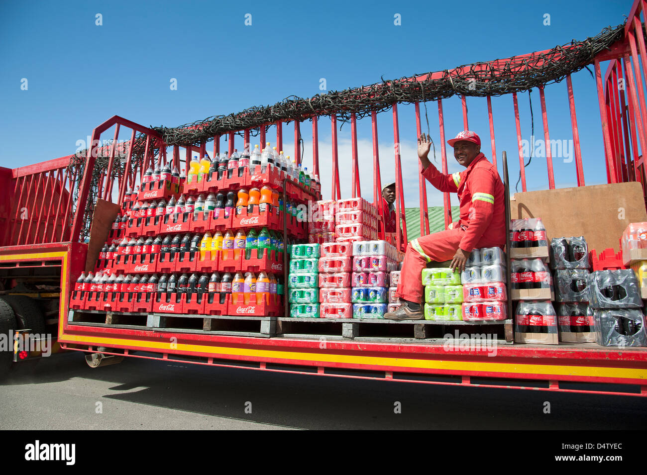 Soft drinks delivery men on their truck delivering cans and bottles of drink Stock Photo