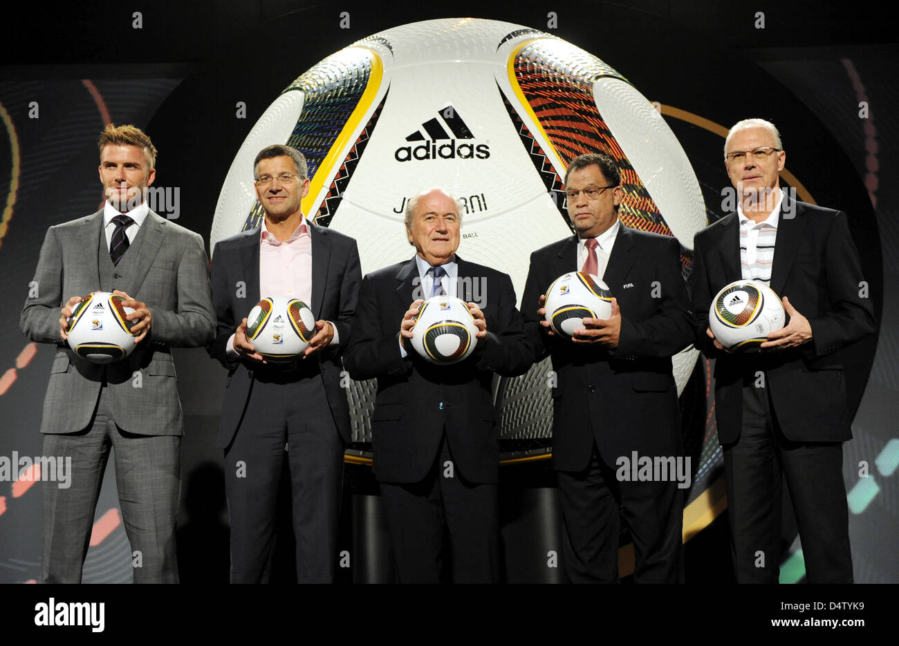 (L-R) England international David Beckham, adidas CEO Herbert Hainer, FIFA President Joseph Blatter, Danny Jordaan, managing director of the organisation committee, and German soccer legend Franz Beckenbauer pose as Jabulani, the official ball for the FIFA 2010 World Cup South Africa, is handed over in Cape Town, South Africa, 04 December 2009. Jabulani is produced by German compan Stock Photo