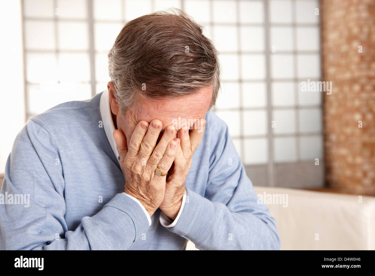 Older man covering face with hands Stock Photo - Alamy