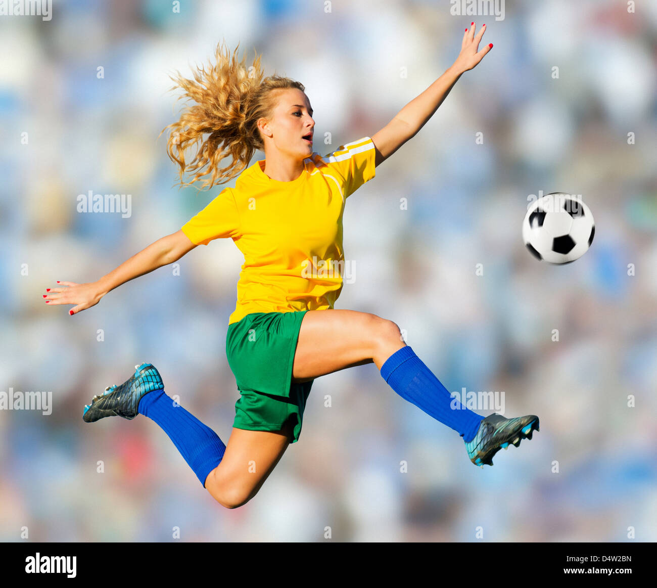 Soccer player kicking in mid-air Stock Photo