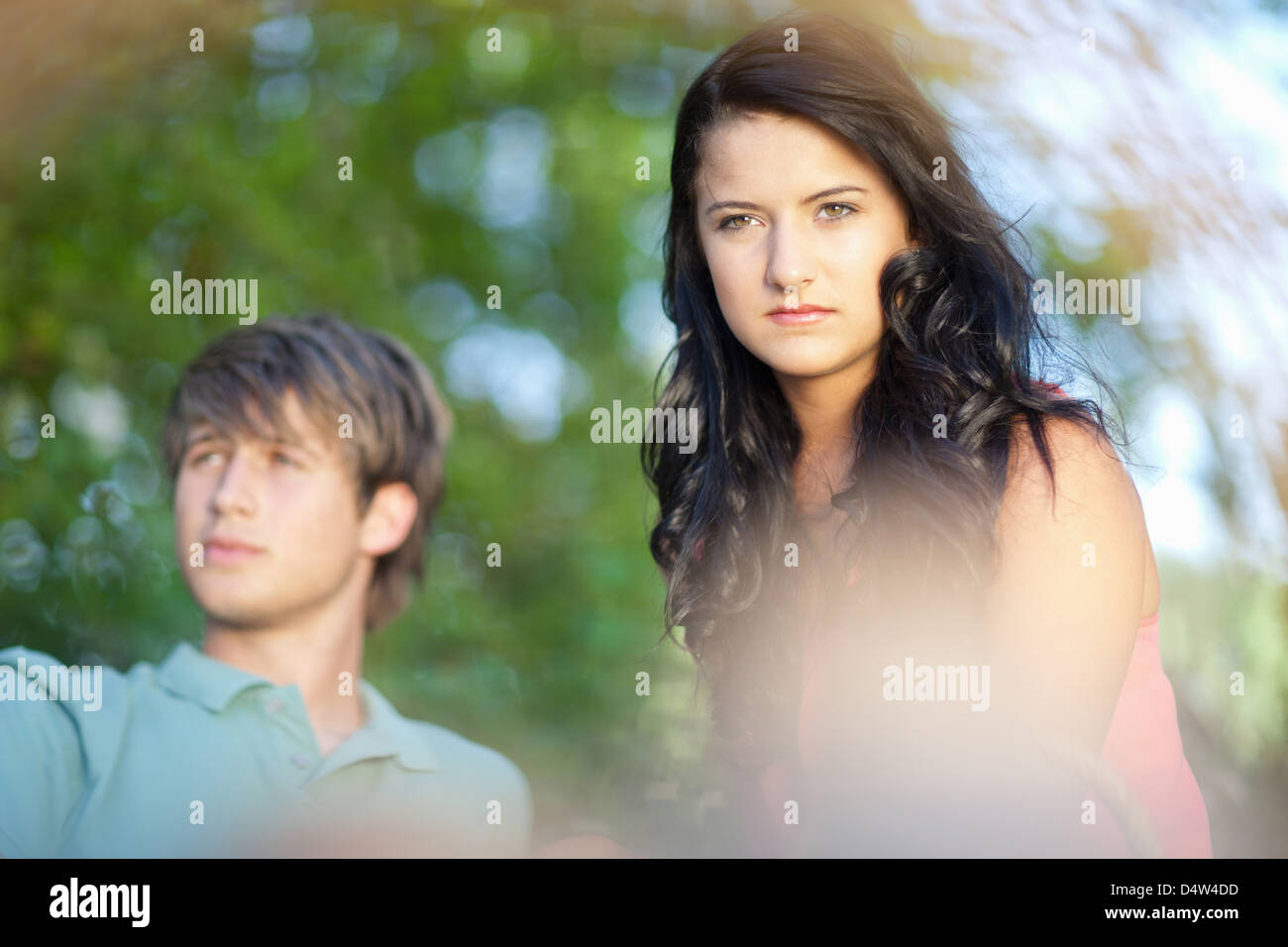 Couple sitting together in park Stock Photo - Alamy