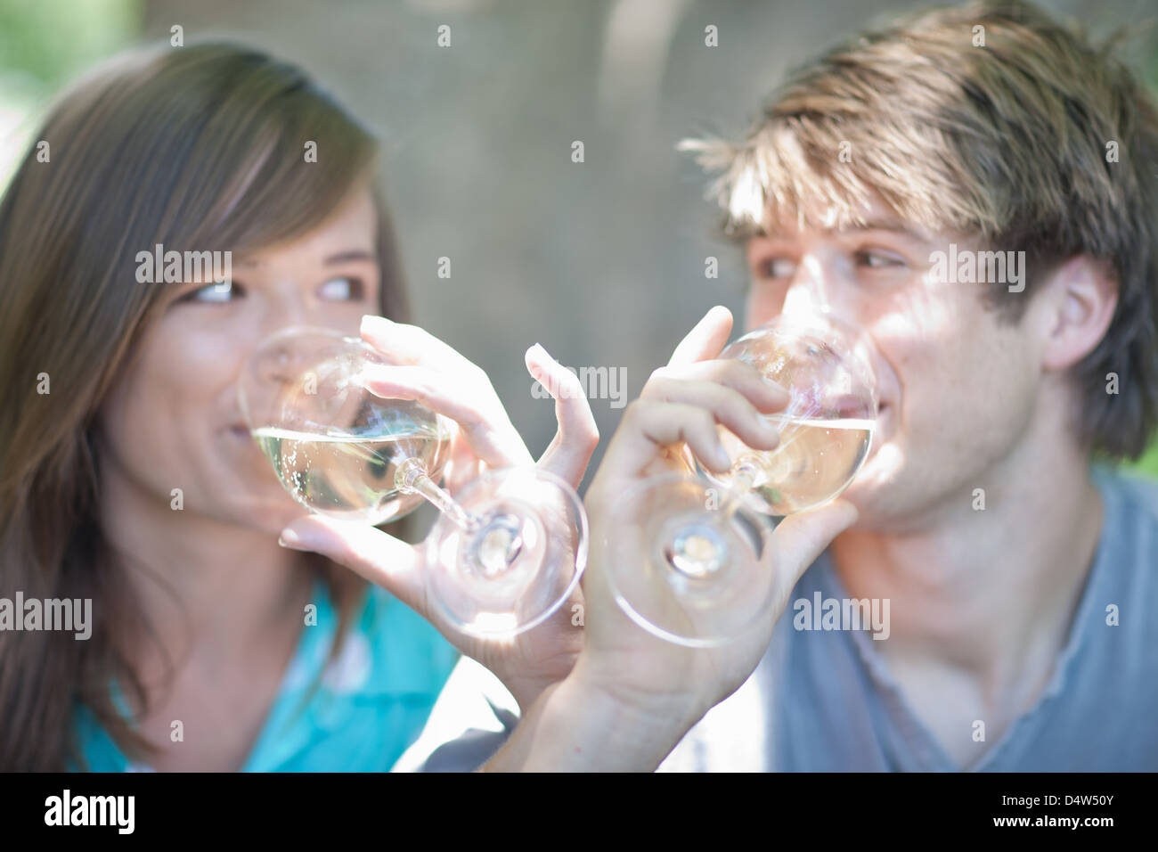Couple drinking wine together outdoors Stock Photo