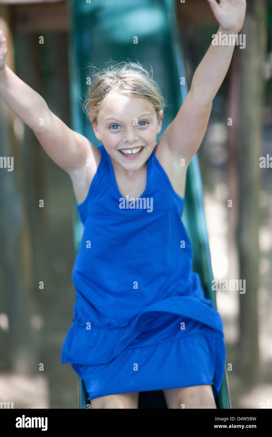 Girl playing on slide outdoors Stock Photo - Alamy
