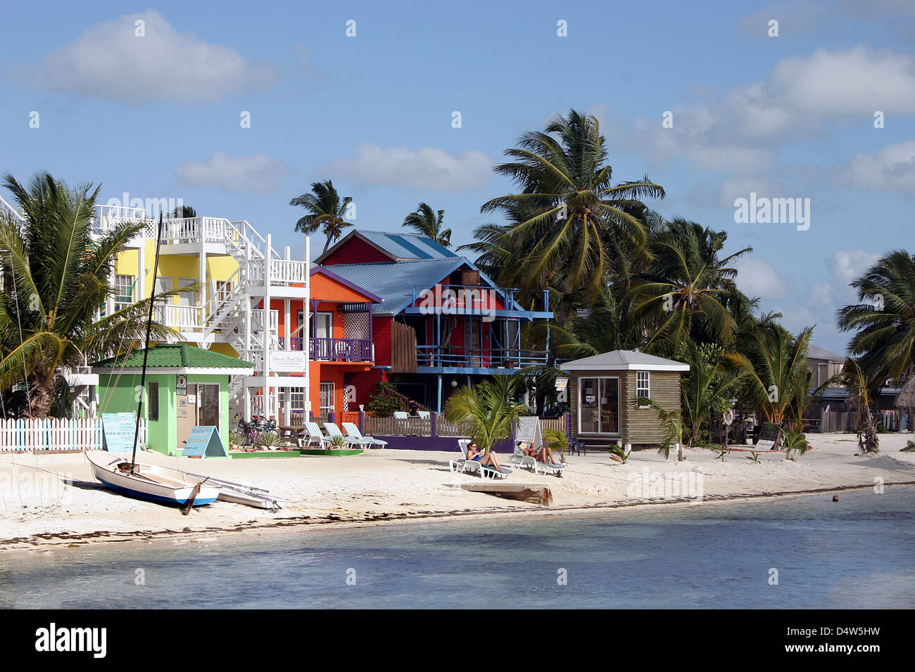 Tropical beach bungalow on Caye Caulker, Belize. Caribbean island architecture and palm trees in the former British Honduras. Travel and vacation. Stock Photo