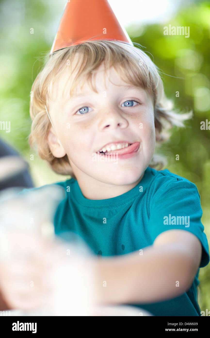 Boy wearing party hat outdoors Stock Photo Alamy