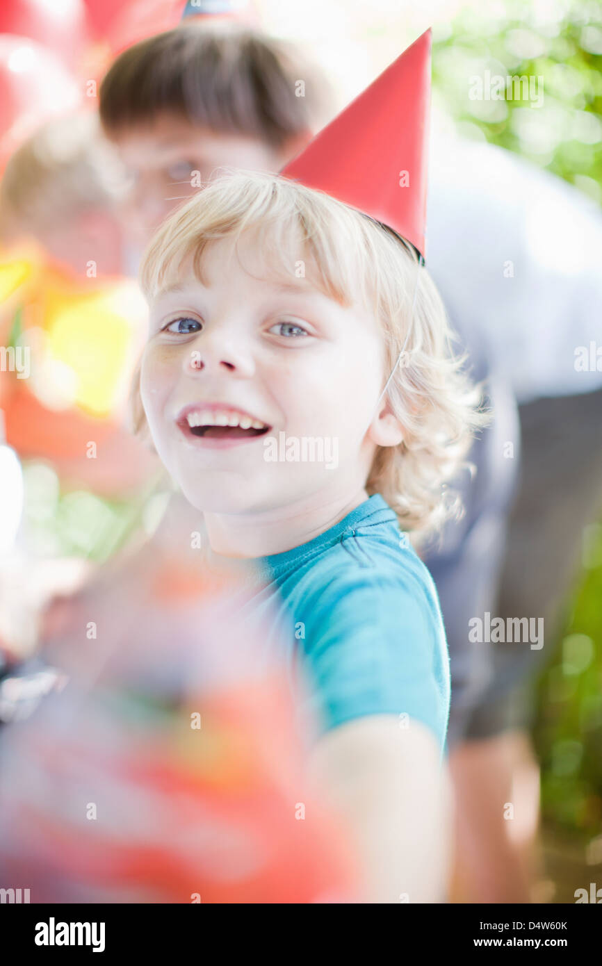 Boy wearing party hat outdoors Stock Photo Alamy