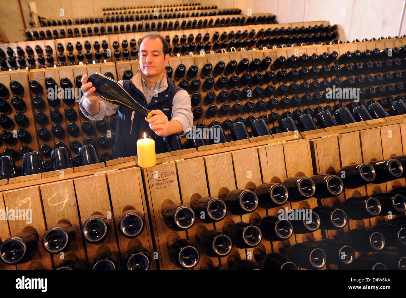 Cellarmaster Juergen Aumueller checks the sparkling wine ''August der