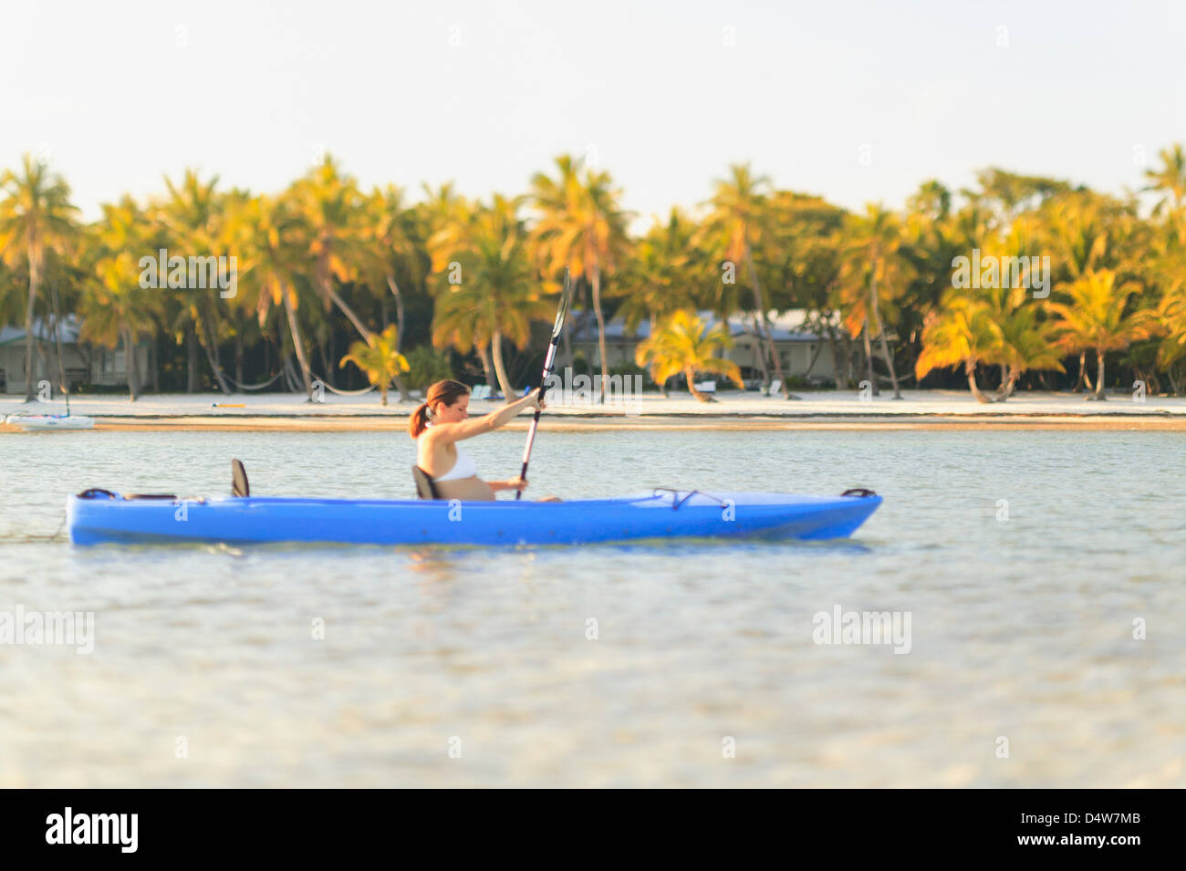 Pregnant woman rowing canoe Stock Photo Alamy