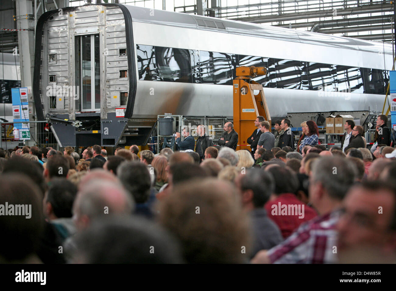 Employees of Bombardier Transportation are assembled in a factory hall