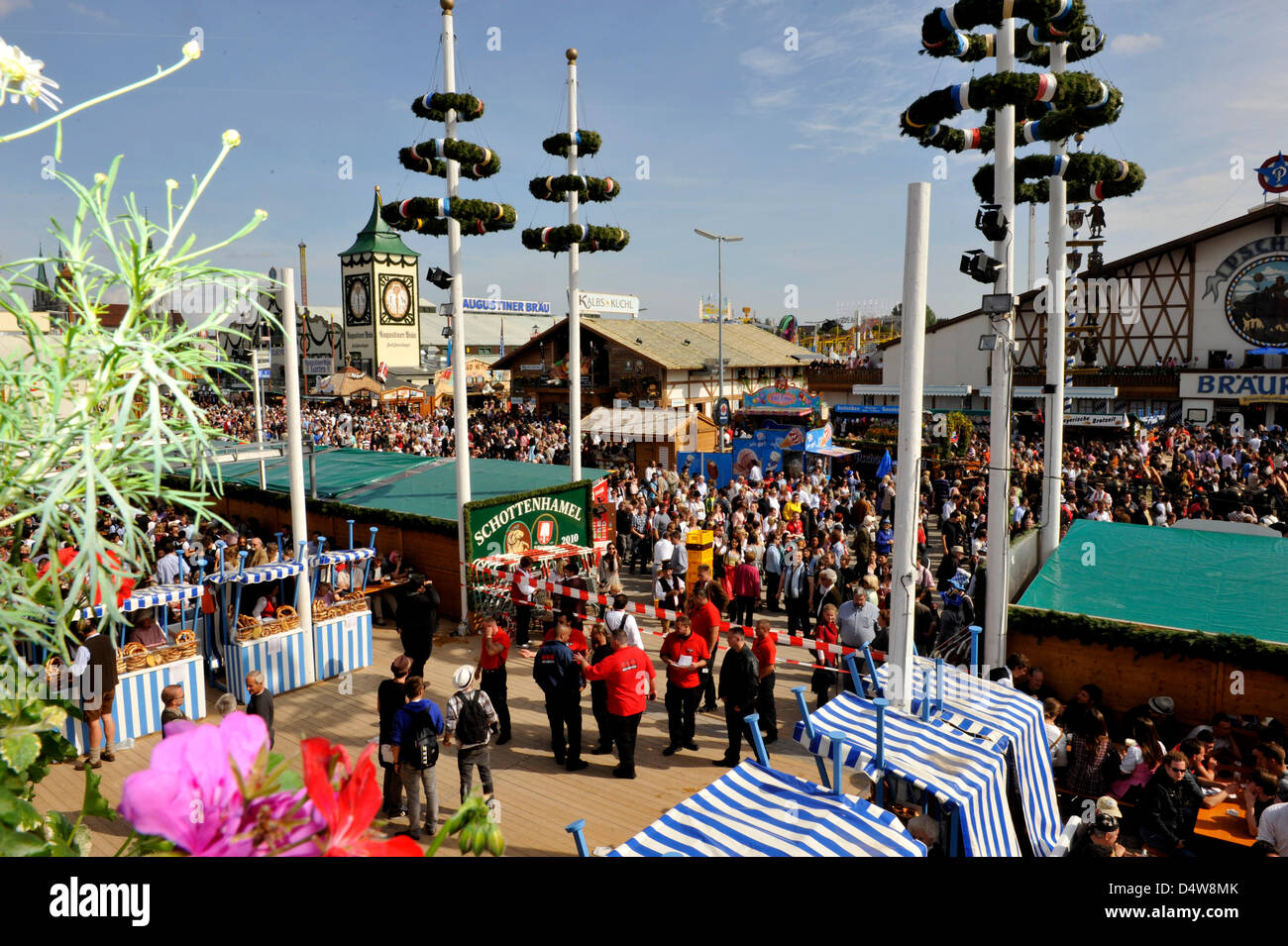 The fairground is crowded and there is blue sky and sun as the 2010