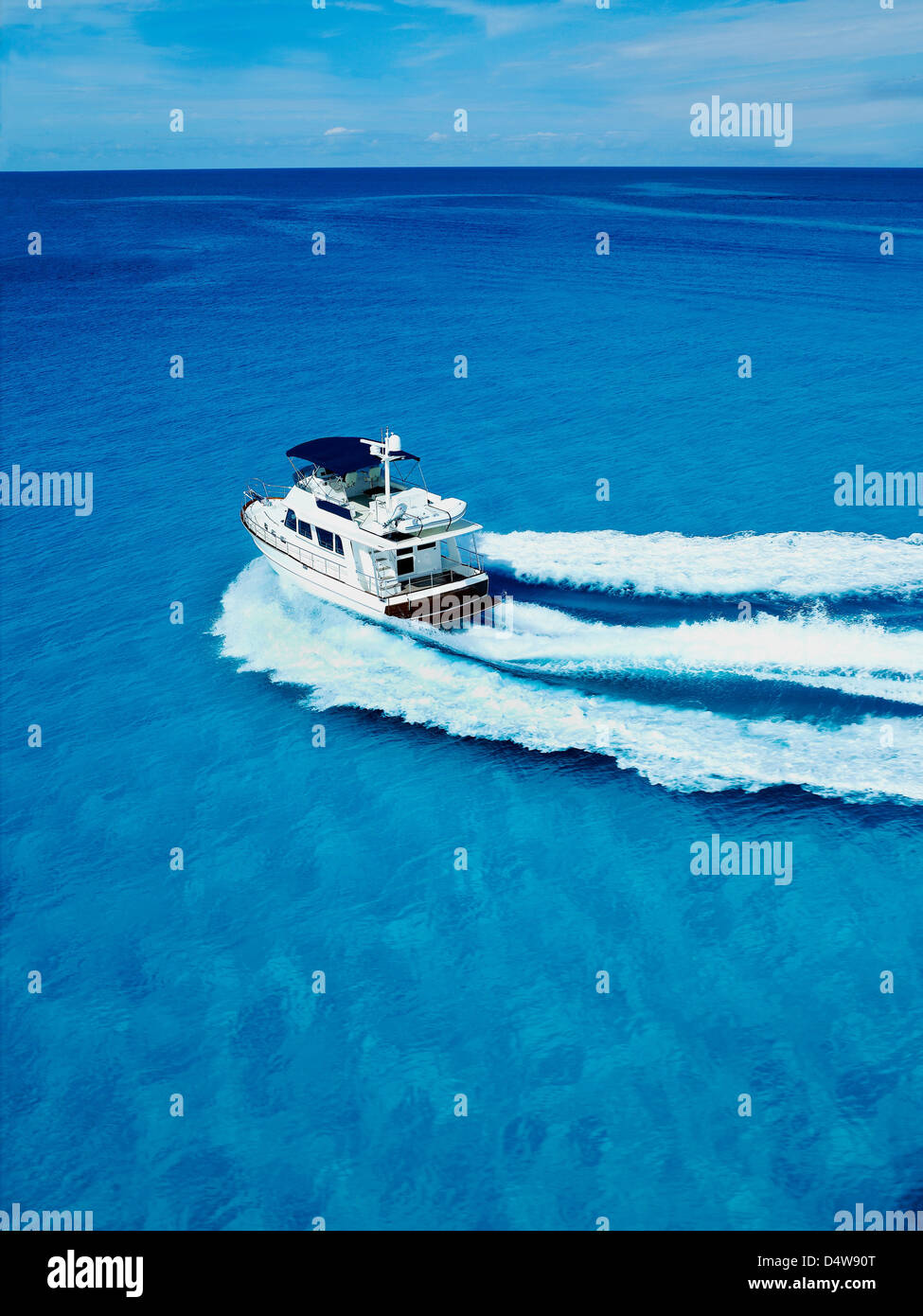 Boat sailing in tropical water Stock Photo