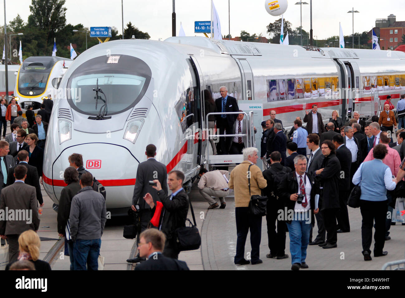 Visitors eye an ICE 3 highspeed train at InnoTrans trade fair in Berlin ...