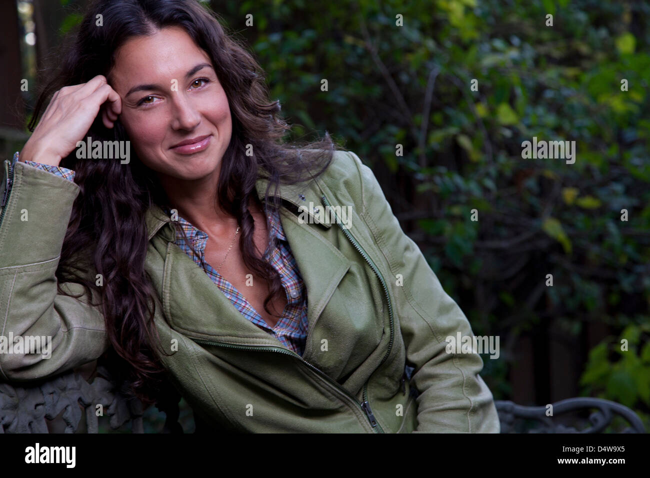 Smiling woman relaxing outdoors Stock Photo