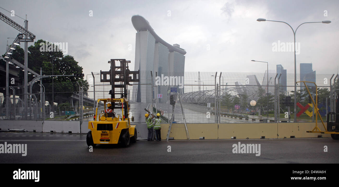 Workers install security fences in front of the Hotel Marina in the rain for the Singapore Grand Prix Formula One Race that will take place on 26 September in Singapore, 32 September 2010. Photo: JAN WOITAS Stock Photo