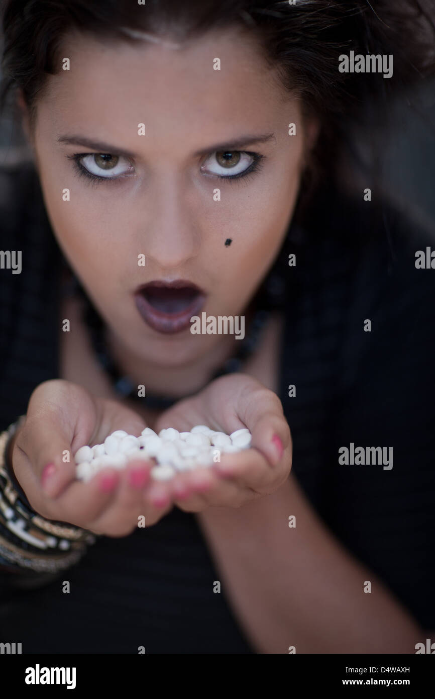 Angry teenage girl holding pills Stock Photo