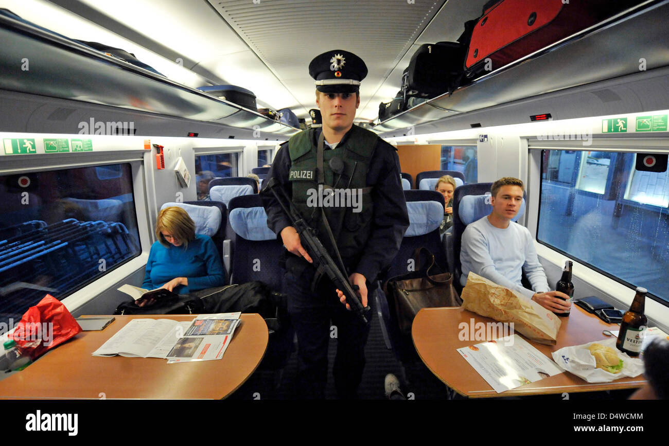 German police officers with bulletproof vests and machine guns patrol