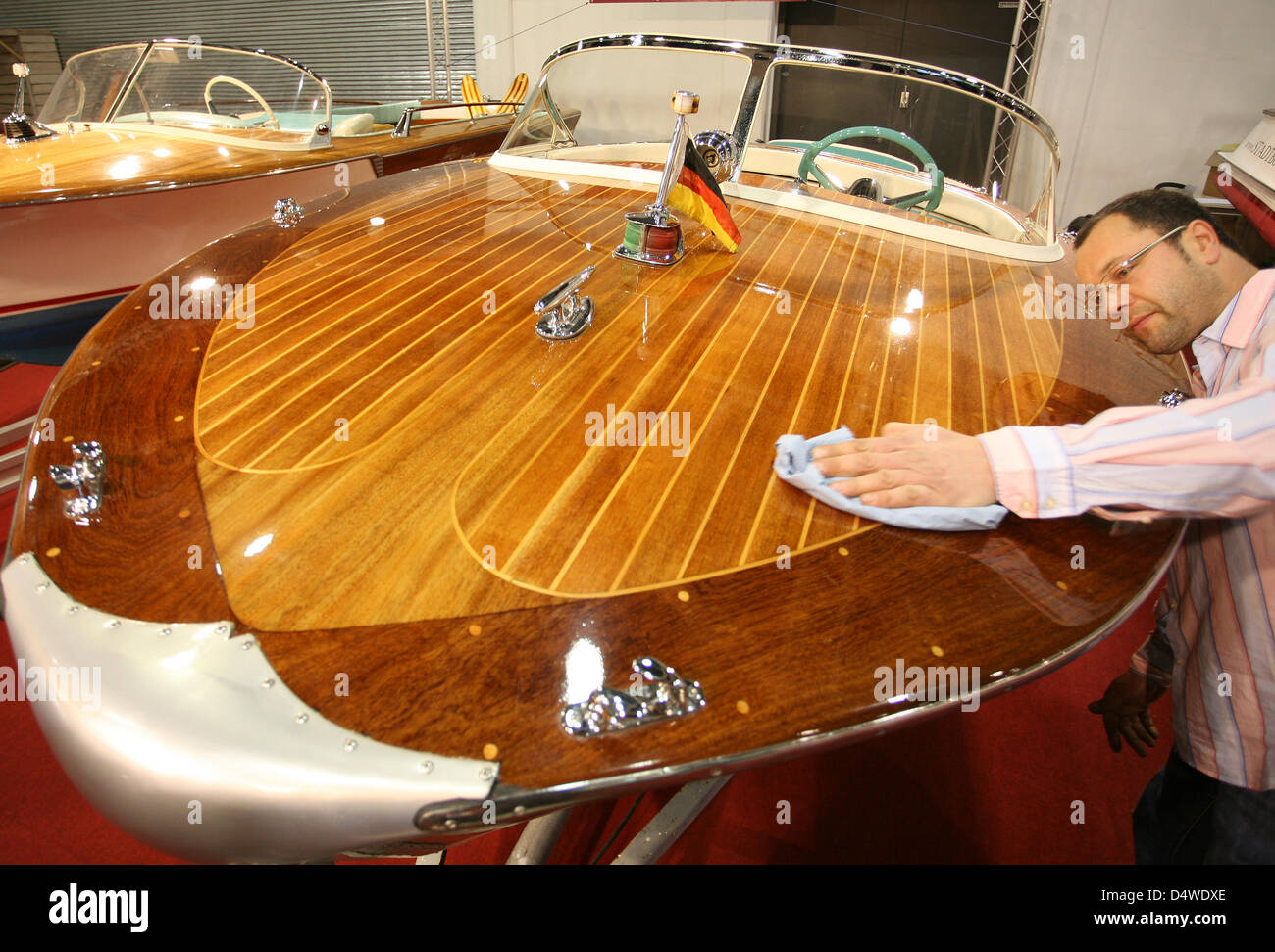 A man polishes a boat at 'Boat and Fun Berlin' trade fair in Berlin, Germany, 24 November 2010. More than 600 exhibitors showcase the their products and services from 24 to 28 November. Photo: Stephanie Pilick Stock Photo