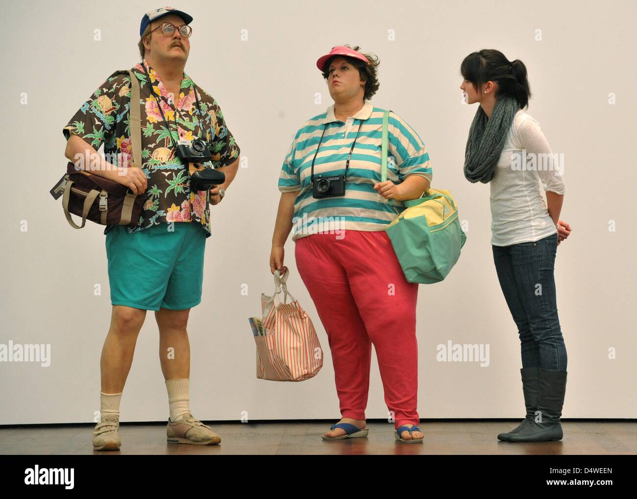 A woman (R) observes the figures 'Tourists II' of the US artist Duane Hanson at the Museum Frieder Burda in Baden Baden, Germany, 24 November 2010. The works are part of the exhibition Duane Hanson - Gregory Crewdson, Uncanny Realities', that takes place between 27 November 2010 and 06 March 2011 at the Museum Frieder Burda. Photo: Rolf Haid Stock Photo